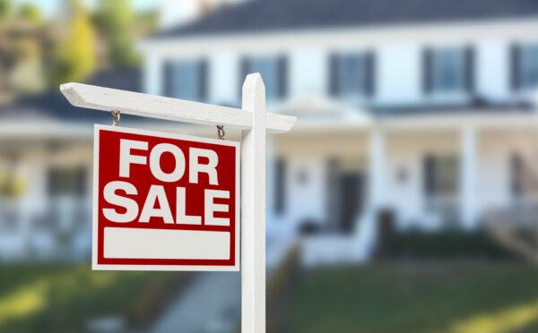 Home,For,Sale,Real,Estate,Sign,In,Front,Of,Beautiful