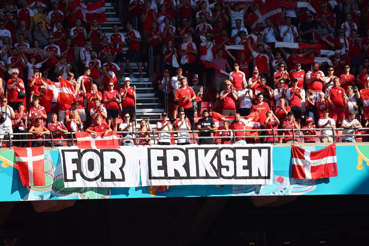 Denmark supporters display a banner for Christian Eriksen, the Danish player who collapsed during the match against Finland last Saturday, June 12, prior to the Euro 2020 soccer championship group B match between Denmark and Belgium, at the Parken stadium in Copenhagen, Denmark on June 17, 2021. (Wolfgang Rattay/Pool via AP)