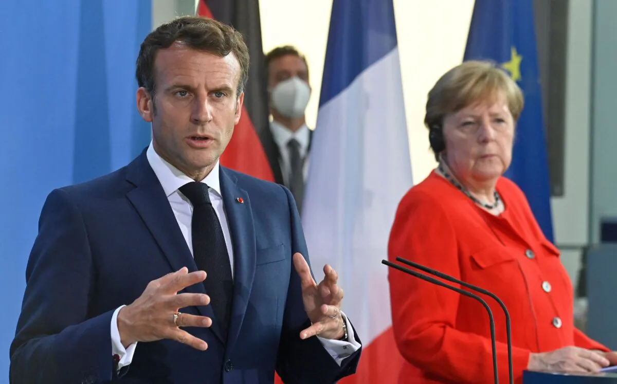 French President Emmanuel Macron gestures during a joint press conference with German Chancellor Angela Merkel ahead of talks at the Chancellery in Berlin on June 18, 2021. (John Macdougall/AFP via Getty Images)