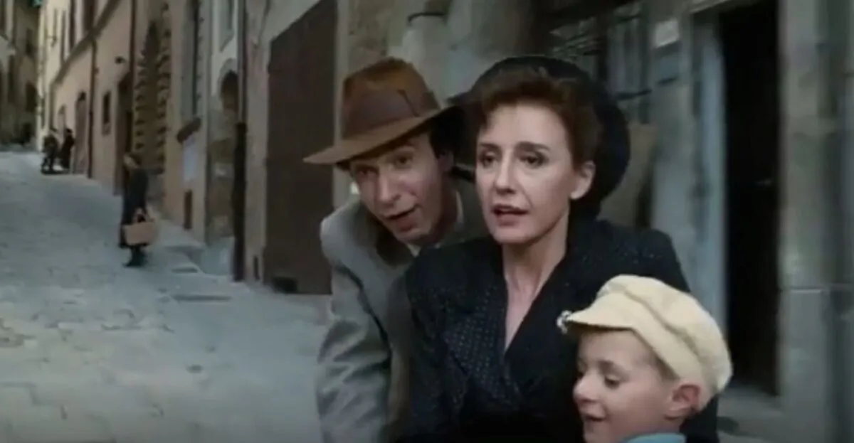 “Life Is Beautiful” starts as a tale of merry courtship and happy family life, starring (L–R) Roberto Benigni, Nicoletta Braschi, and Giorgio Cantarini. (Miramax Films)