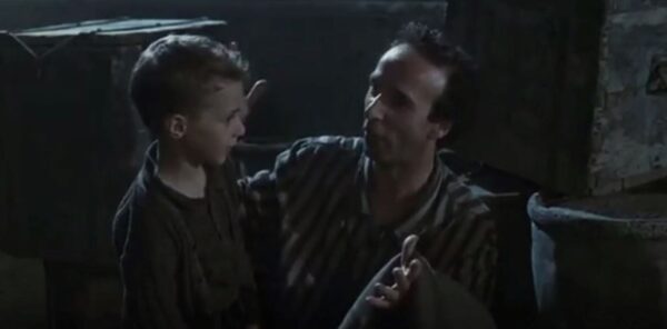 young boy in cell with father