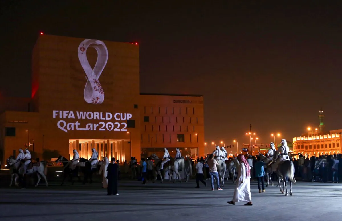 Qataris gather at the capital Doha's traditional Souq Waqif market as the official logo of the FIFA World Cup Qatar 2022 is projected on the front of a building, on Sept. 3, 2019. (AFP via Getty Images)