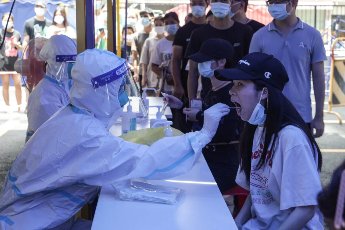 A woman takes a COVID-19 test in Guangzhou, in China's southern Guangdong Province, on May 30, 2021. (STR/AFP via Getty Images)