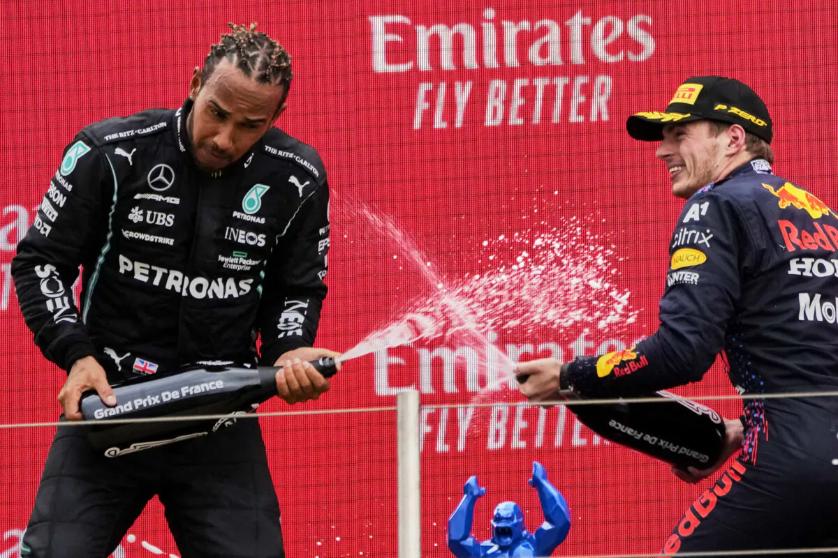 Red Bull driver Max Verstappen of the Netherlands (R) celebrates from the podium after winning, with second place Mercedes driver Lewis Hamilton of Britain (L) from the podium during the French Formula One Grand Prix at the Paul Ricard racetrack in Le Castellet, southern France, on June 20, 2021. (Francois Mori/AP Photo)