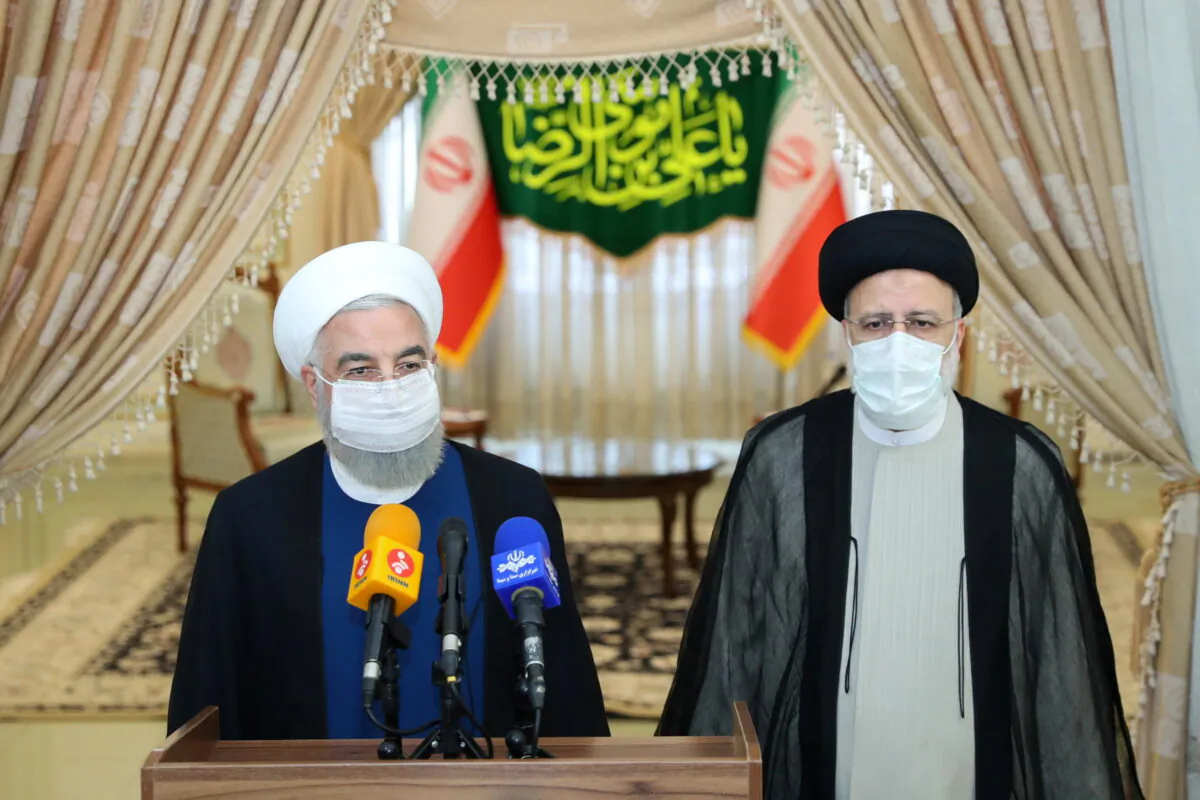 Iran's outgoing President Hassan Rouhani (L) and Iran's President-elect Ebrahim Raisi (R) speak to the media after their meeting in Tehran, Iran, on June 19, 2021. (Official Presidential website/Handout via Reuters)