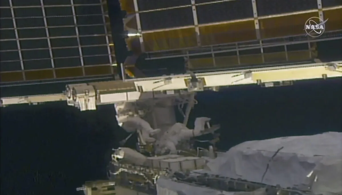 In this image taken from NASA video, NASA astronaut Shane Kimbrough (L) and French astronaut Thomas Pesquet work on the solar array outside the International Space Station, on June 20 2021. (NASA via AP)