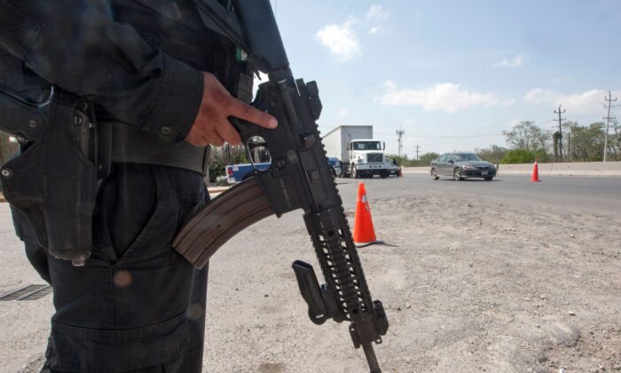 Members of the federal police stand guard at a checkpoint in the border city of Reynosa, Tamaulipas, Mexico, April 6, 2018.  (Julio Cesar Aguilar/AFP via Getty Images)