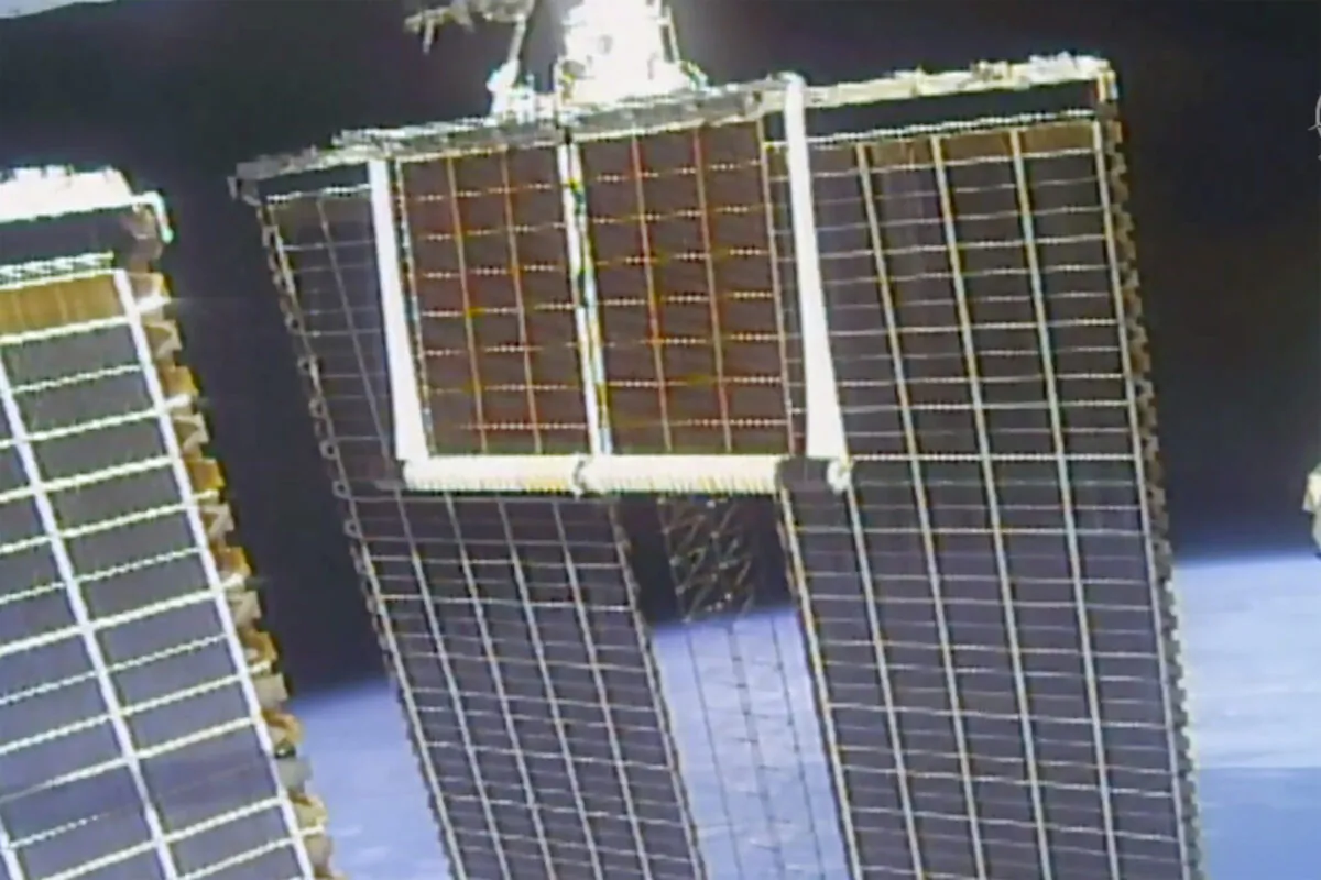 In this image taken from NASA video, a solar panel is unfolded at the International Space Station on June 20 2021. (NASA via AP)
