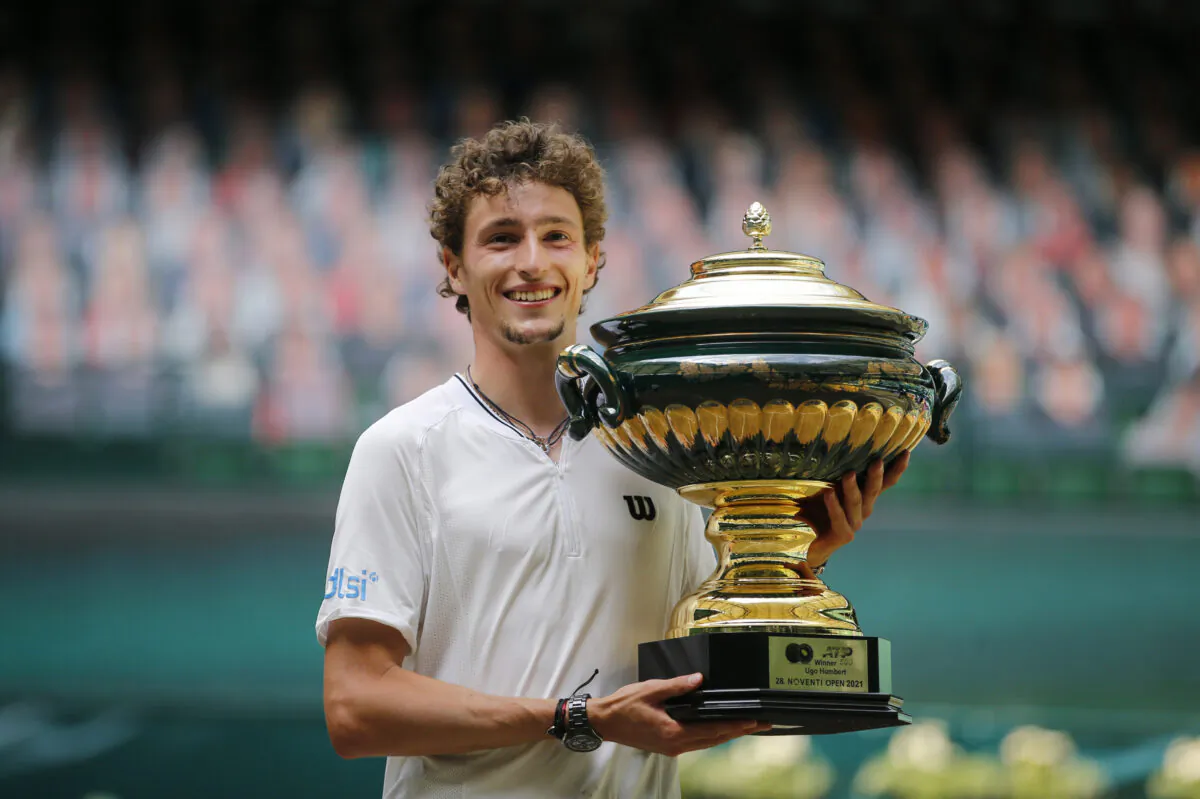 France's Ugo Humbert poses with a trophy as he celebrates after winning the final against Russia's Andrey Rublev, at the ATP 500 Halle Open tennis tournament at the Gerry Weber Stadion, in Halle, Germany, on June 20, 2021. (Leon Kuegeler/Reuters)