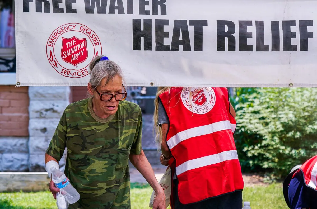 A pedestrian holds a bottle of cold water at a Salvation Army hydration station during a heatwave as temperatures hit 115 degrees F in Phoenix, on June 15, 2021. (Ross D. Franklin/File/AP Photo)