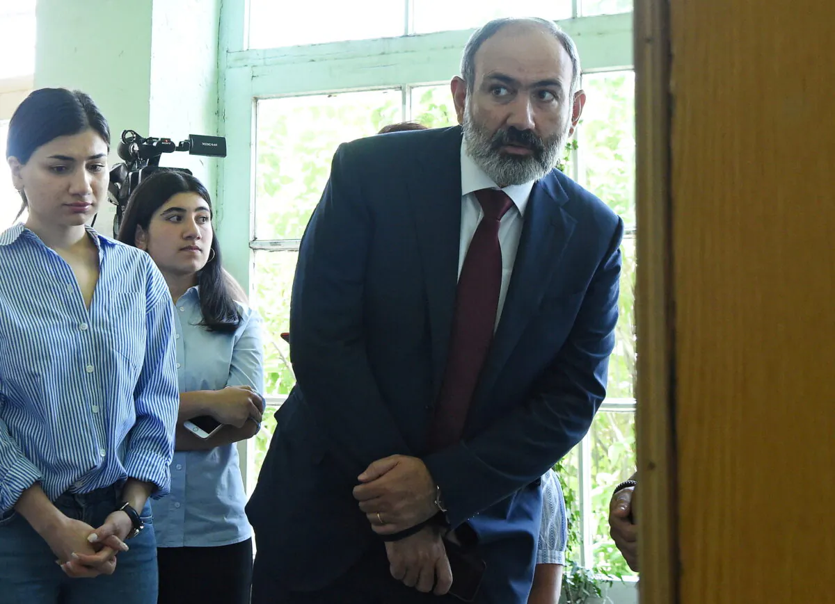 Armenia's acting Prime Minister and leader of Civil Contract party Nikol Pashinyan visits a polling station to cast his vote during the snap parliamentary election in Yerevan, Armenia, on June 20, 2021. (Lusi Sargsyan/Photolure via Reuters)