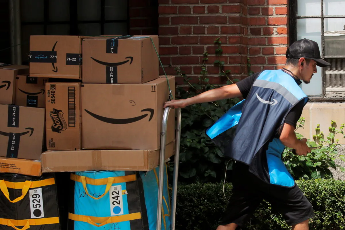 An Amazon delivery worker pulls a delivery cart full of packages during its annual Prime Day promotion in New York on June 21, 2021. (Brendan McDermid/Reuters)
