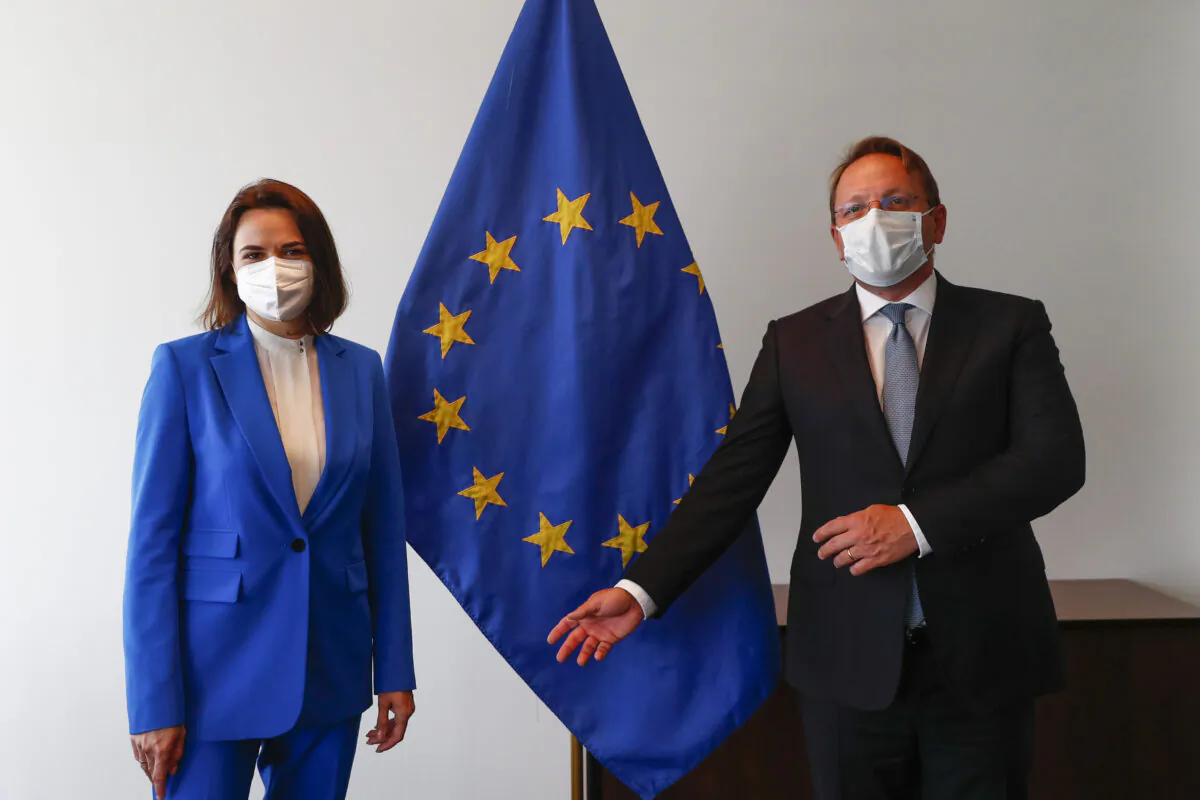 Belarusian opposition politician Sviatlana Tsikhanouskaya, left, and European Commissioner for Neighbourhood and Enlargement Oliver Varhelyi pose for a photo during a European Foreign Affairs Ministers meeting at the European Council building in Luxembourg, on June 21, 2021. (Johanna Geron/Pool Photo via AP)