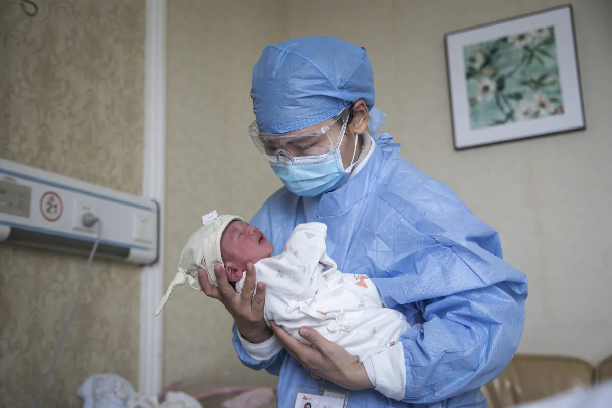 A nurse holding a baby in a private obstetric hospital in Wuhan city, Hubei Province, China, on Feb. 21, 2020. (Getty Images)