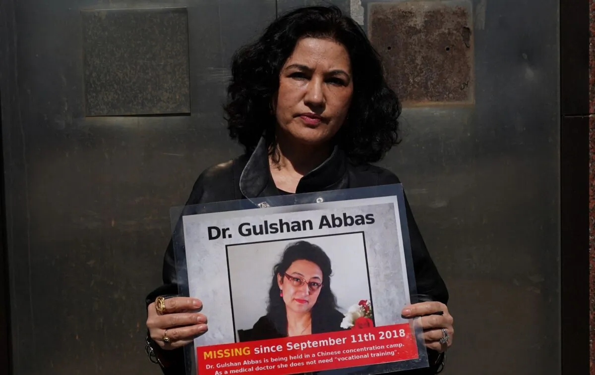 Rushan Abbas, executive director of Campaign for Uyghurs, holds a photo of her sister, Dr. Gulshan Abbas, who is currently imprisoned in a Chinese camp, during a rally in New York on March 22, 2021. (Timothy Clary/AFP via Getty Images)