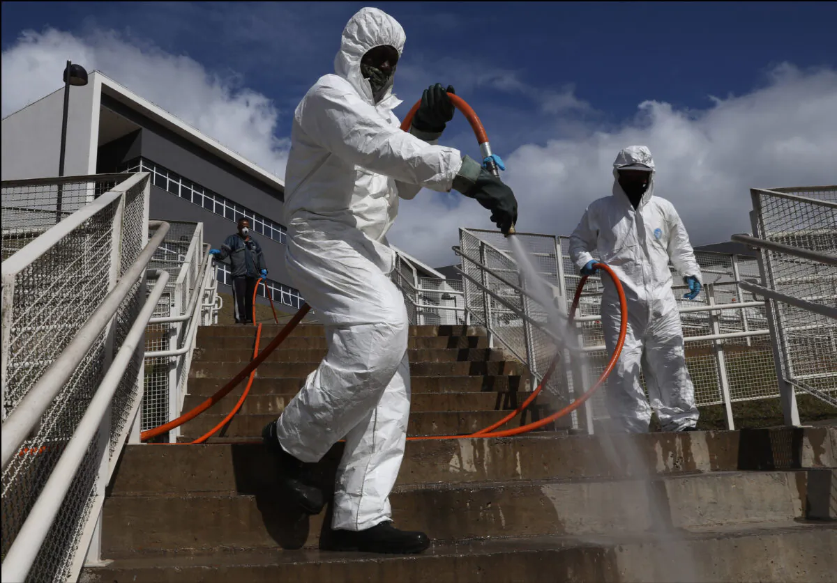 City hall employees disinfect stairs at Municipal Hospital of Parelheiros in Sao Paulo, Brazil, on June 18, 2021. (Rodrigo Paiva/Getty Images)
