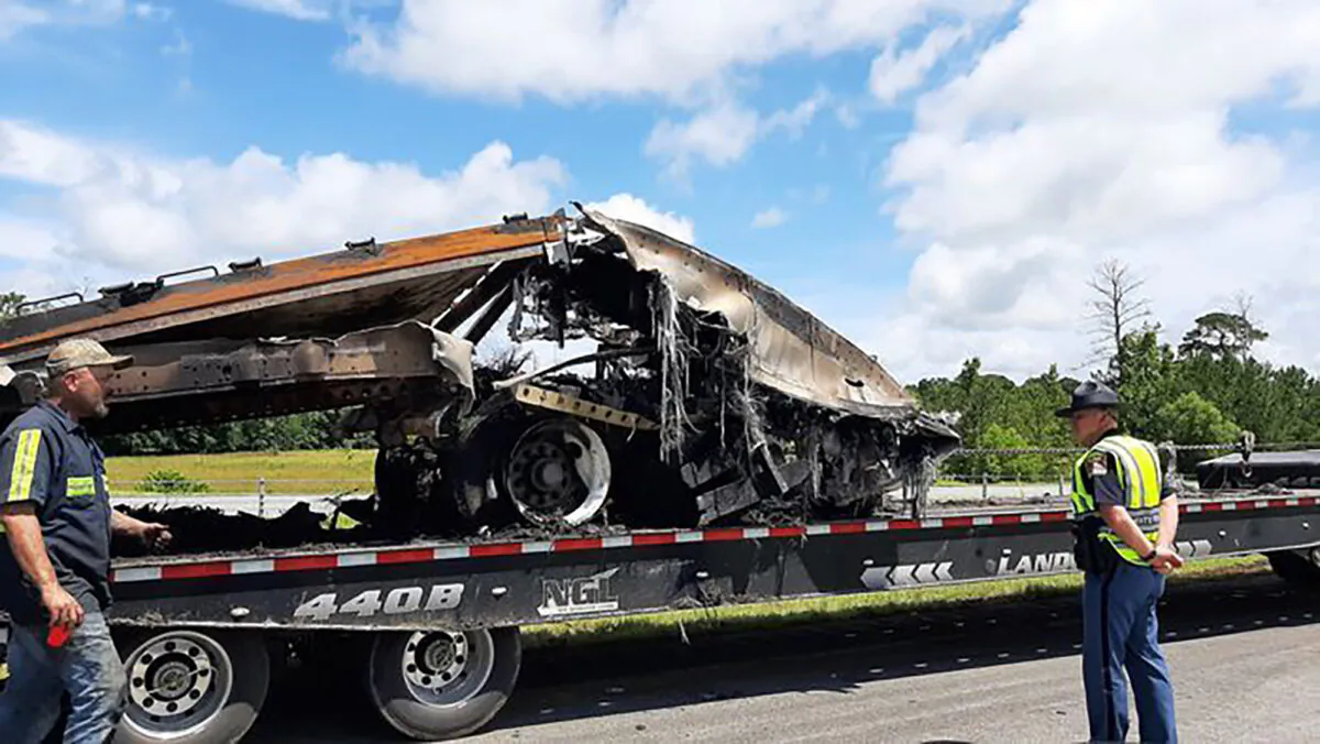 Some of the wreckage from a fatal multiple-vehicle crash a day earlier is loaded to be carried away, in Butler County, Ala., on June 20, 2021. (Lawrence Specker/Press-Register/AL.com via AP)