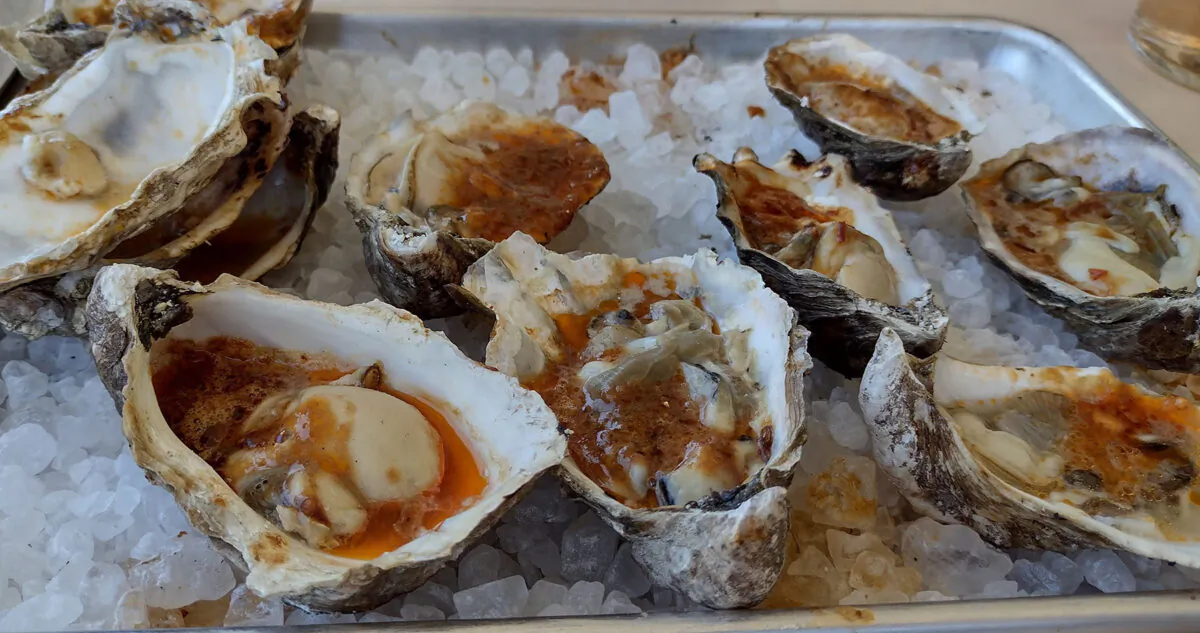 Fresh grilled oysters in bubbling chipotle butter are popular offerings on the menu at FINCA Paso Robles. (Courtesy of Jim Farber)