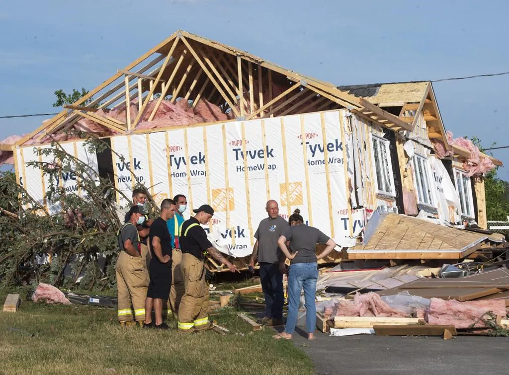 A man surveys the damage after a tornado touched down in Mascouche, Que., northeast of Montreal, on June 21, 2021. Dozens of homes were damaged and one death has been confirmed. (The Canadian Press/Ryan Remiorz)