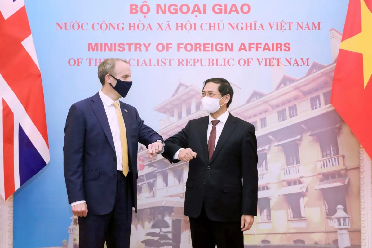 Britain's Foreign Secretary Dominic Raab, left, and Vietnamese Foreign Minister Bui Thanh Son greet with an elbow bump in Hanoi, Vietnam, on Jun. 22, 2021. (Bui Lam Khanh/VNA via AP)