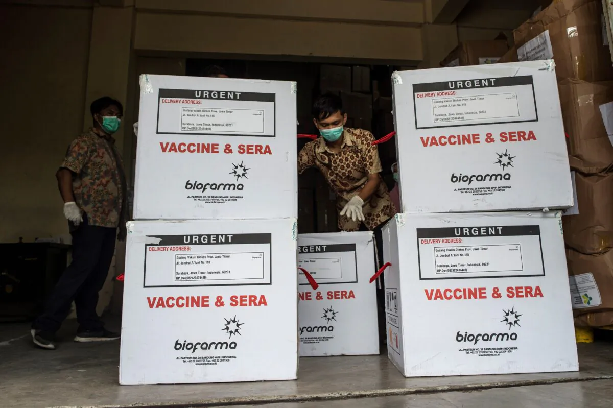 A health worker checks the containers of Covid-19 vaccine produced by China's Sinovac, as they arrived in Surabaya, a city in Indonesia, on Jan. 13, 20210. Juni Kriswanto/AFP via Getty Images)