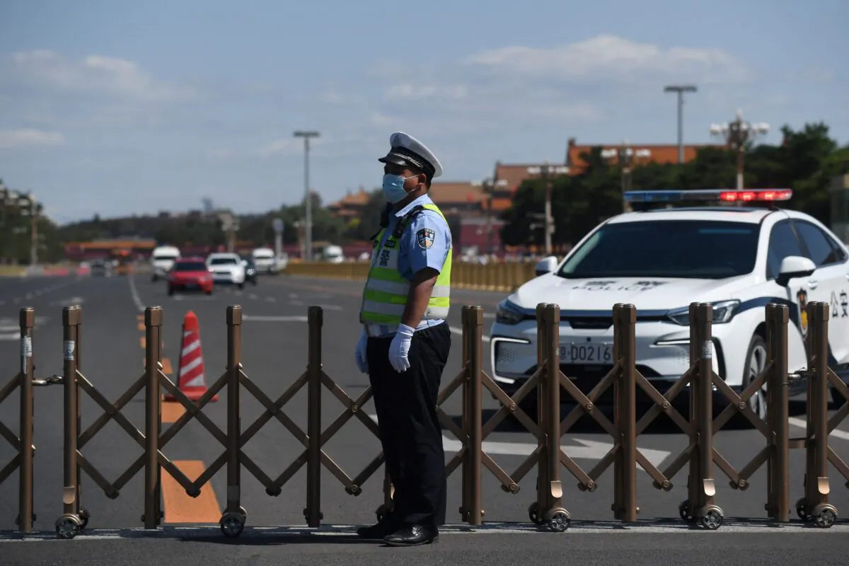 A police officer keeps watch on the road that surrounds Tiananmen Square in Beijing on June 4, 2021. (Greg Baker/AFP via Getty Images)
