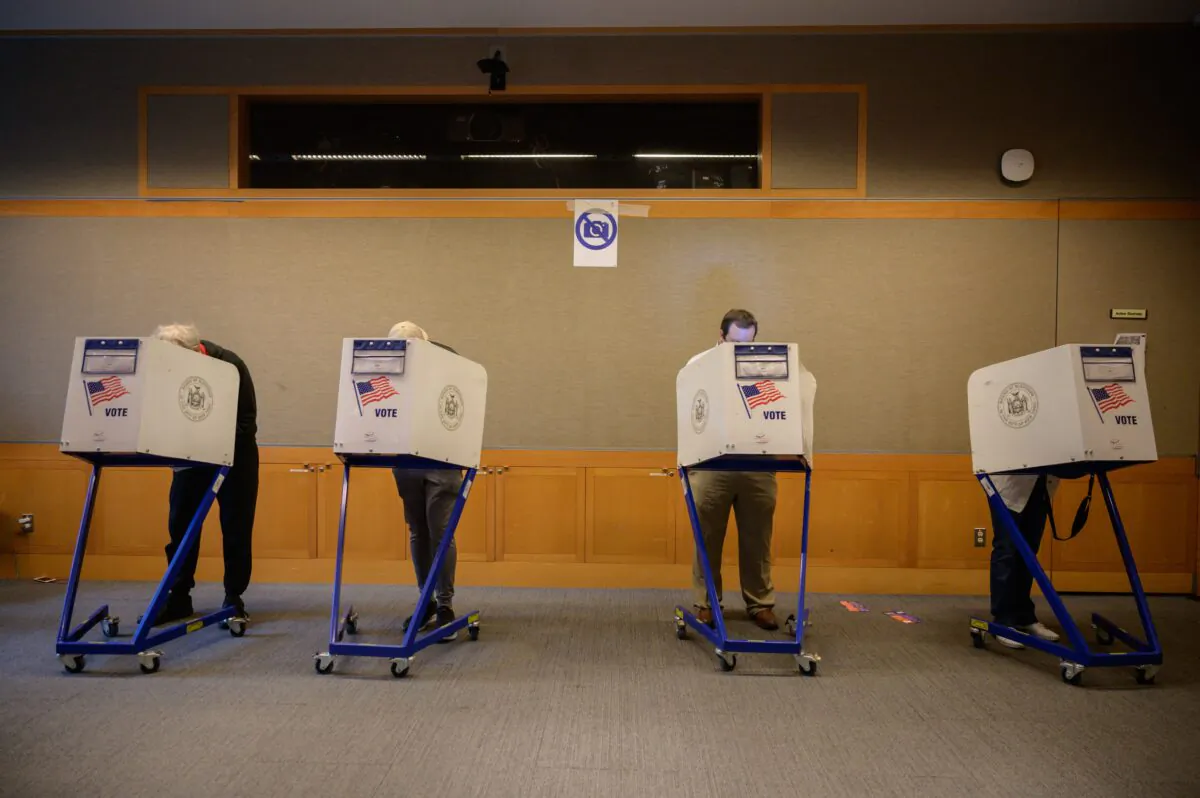 Voters stand in booths at a voting station at the Metropolitan Museum of Art during the mayoral election process in New York on June 12, 2021. (Ed Jones/AFP via Getty Images)