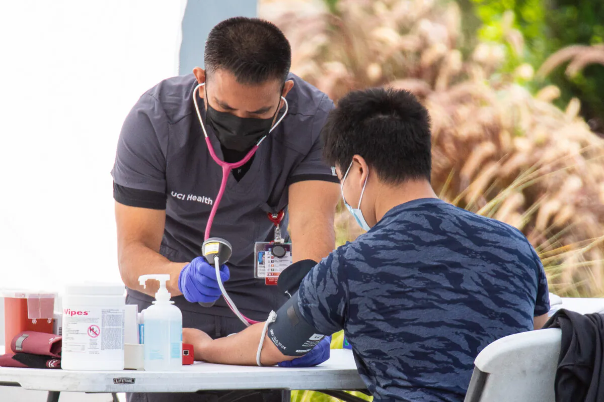 University of California–Irvine medical staff draw blood from volunteers to maintain a summer season surplus in Irvine, Calif., on June 22, 2021. (John Fredricks/The Epoch Times)