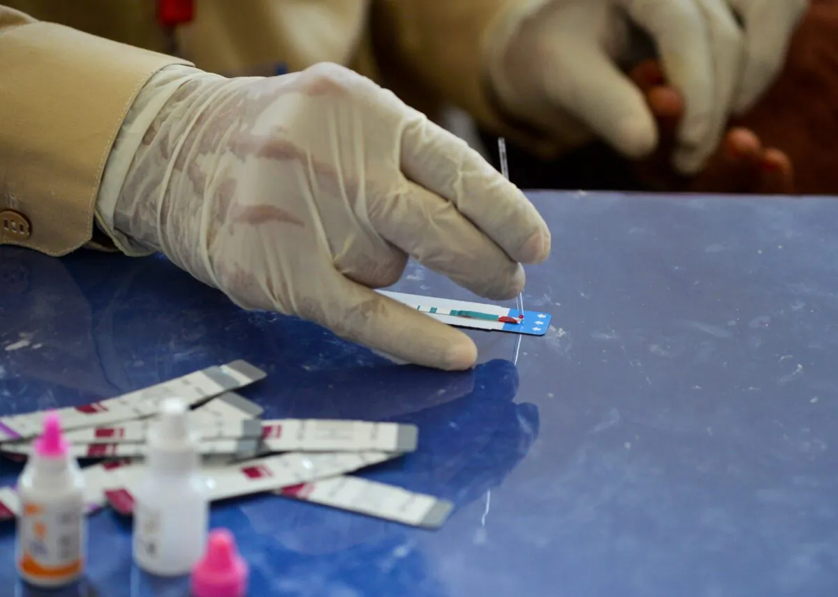 A Pakistani doctor examines the blood sample from a woman for a HIV test at a state-run hospital in Rato Dero in the district of Larkana of the southern Sindh province, Pakistan, on May 8, 2019. (Rizwan Tabassum/AFP via Getty Images)