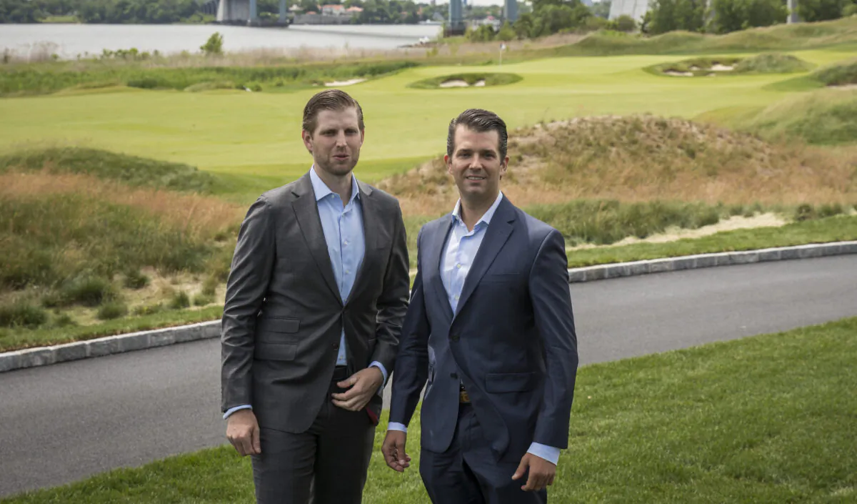 Eric Trump (L) and Donald Trump Jr. pose for photos during a ribbon cutting event for a new clubhouse at Trump Golf Links at Ferry Point in the Bronx borough of New York, on June 11, 2018. (Drew Angerer/Getty Images)