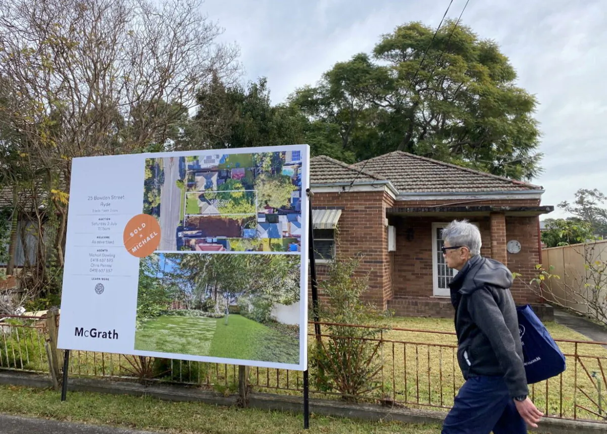 A man walks past a derelict home, which sold for A$1.6 million ($1.2 million), in Sydney's northwest in Australia June 23, 2021. (Swati Pandey/Reuters)