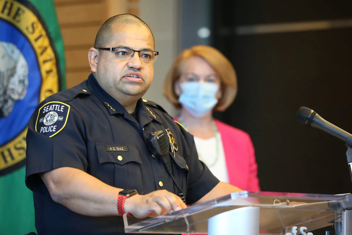 Adrian Diaz, then-deputy chief of the Seattle Police Department, speaks at a news conference as Seattle Mayor Jenny Durkan (R) looks on at City Hall on Aug. 11, 2020. (Karen Ducey/Getty Images)