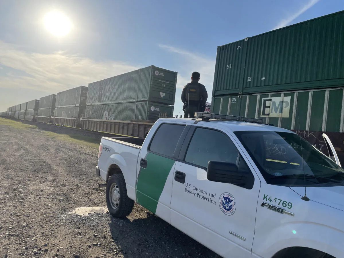 A Border Patrol agent searches a train for illegal aliens near Uvalde, Texas, on June 11, 2021. (Charlotte Cuthbertson/The Epoch Times)