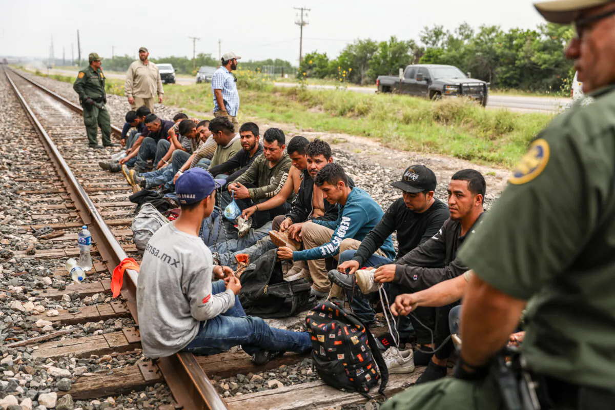 Border Patrol agents apprehend 21 illegal aliens from Mexico who had hidden in a grain hopper on a freight train heading to San Antonio, near Uvalde, Texas, on June 21, 2021. (Charlotte Cuthbertson/The Epoch Times)