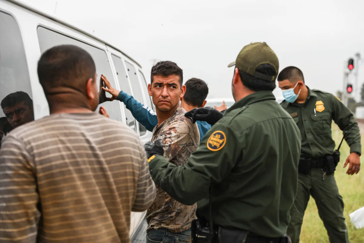 Border Patrol agents apprehend illegal aliens from Mexico who had hidden in a grain hopper on a freight train heading to San Antonio, near Uvalde, Texas, on June 21, 2021. (Charlotte Cuthbertson/The Epoch Times)
