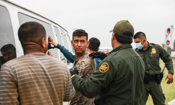 Border Patrol agents apprehend illegal aliens from Mexico who had hidden in a grain hopper on a freight train heading to San Antonio, near Uvalde, Texas, on June 21, 2021. (Charlotte Cuthbertson/The Epoch Times)