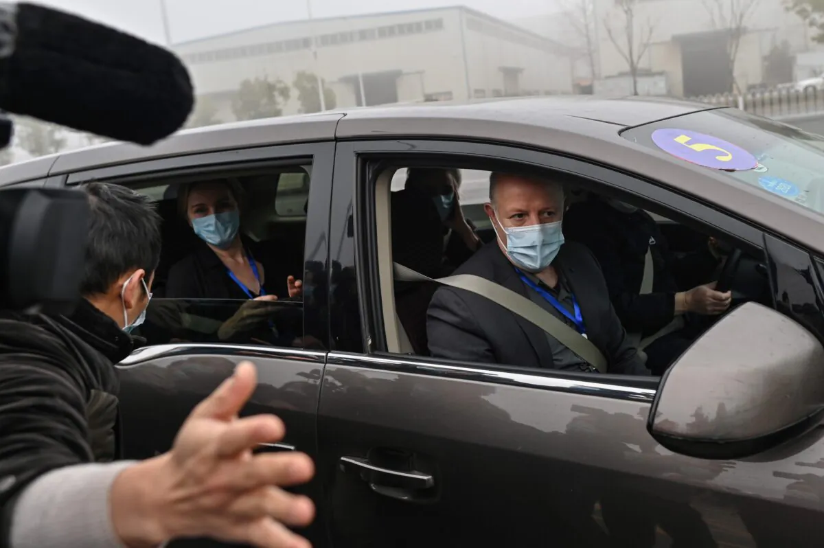 Peter Daszak (R) and other members of the World Health Organization team investigating the origins of the COVID-19 coronavirus, arrive at the Wuhan Institute of Virology in Wuhan, Hubei Province, China, on Feb. 3, 2021. (Hector Retamal/AFP via Getty Images)