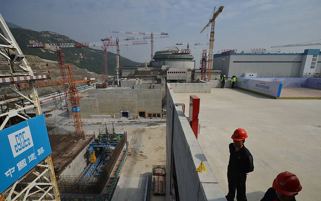 Workers wait for French Prime Minister Jean-Marc Ayrault to arrive at the joint Sino-French Taishan Nuclear Power Station outside the city of Taishan in Guangdong Province, China, on Dec. 8, 2013. French Prime Minister Jean-Marc Ayrault touted his country's nuclear expertise during his visit to China—the world's largest market for atomic power stations. (Peter Parks/AFP via Getty Images)