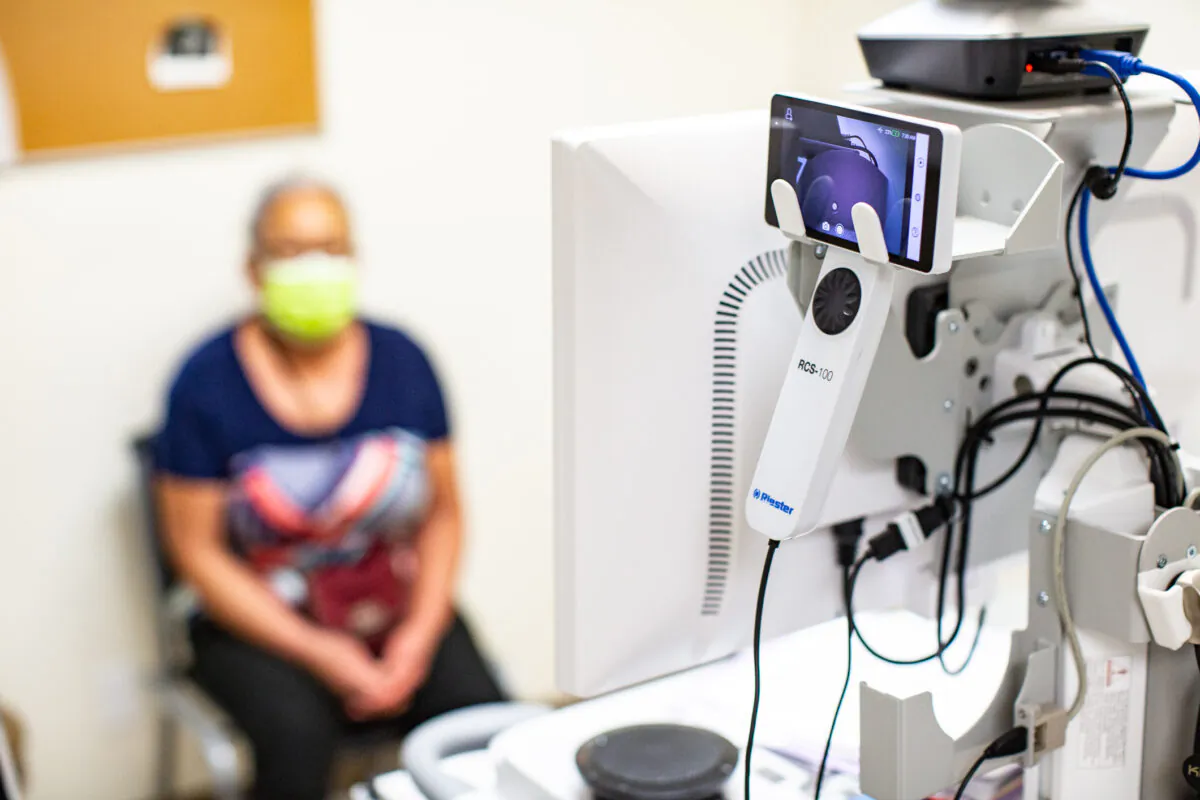 A patient at the Lestonnac Free Clinic talks with a doctor about her health issues using a telemedicine machine in Orange, Calif., on June 21, 2021. (John Fredricks/The Epoch Times)