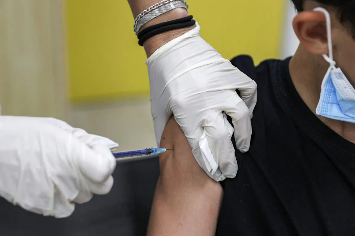 A boy receives a dose of the Pfizer/BioNTech COVID-19 vaccine in Holon, Israel on June 21, 2021. (Jack Guez/AFP via Getty Images)