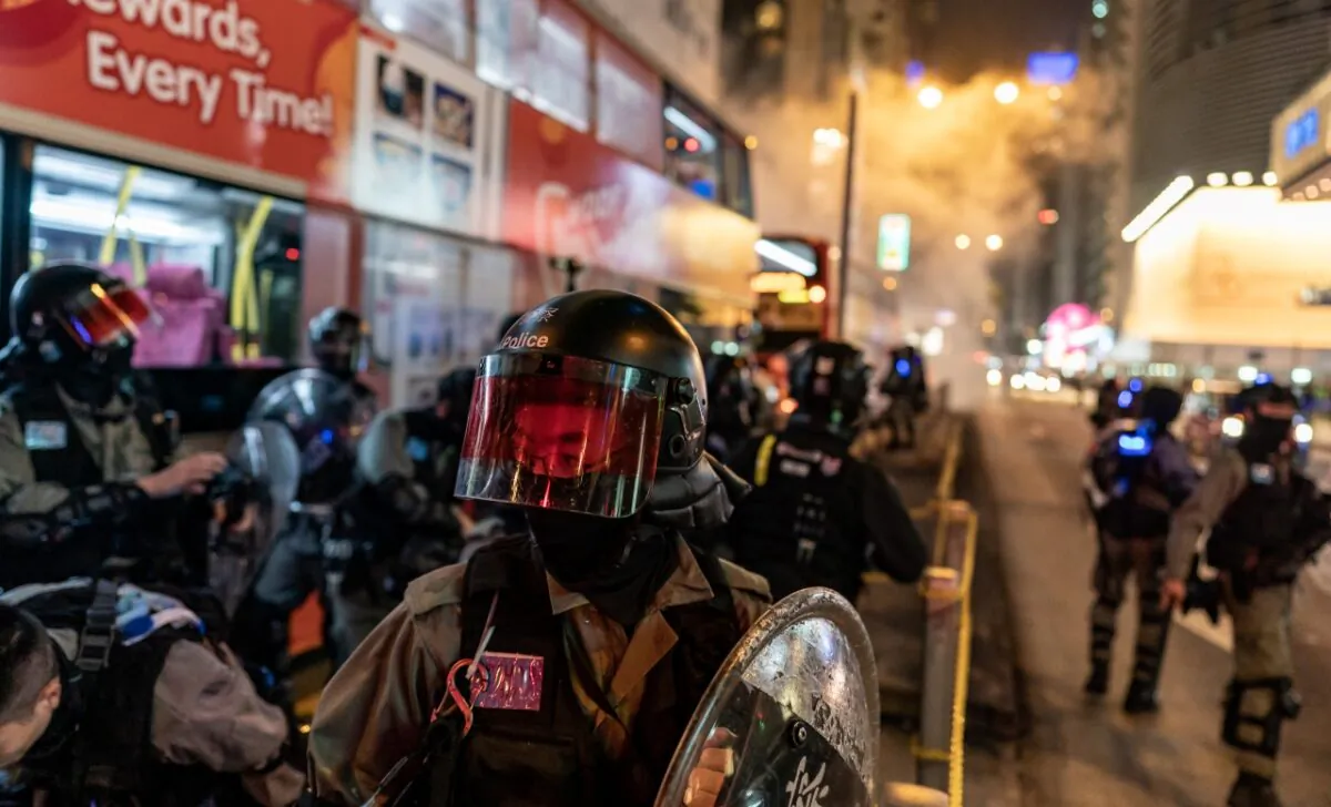 Riot police react after firing teargas to disperse protesters in Hong Kong, China on Dec. 24, 2019. (Anthony Kwan/Getty Images)
