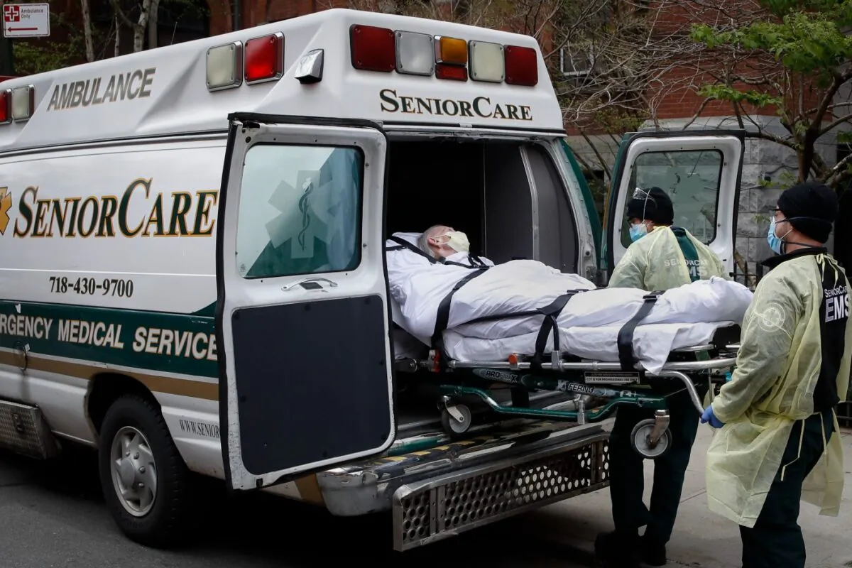 A patient is loaded into an ambulance by emergency medical workers outside Cobble Hill Health Center in the Brooklyn borough of New York, on April 17, 2020. (John Minchillo/File/AP Photo)