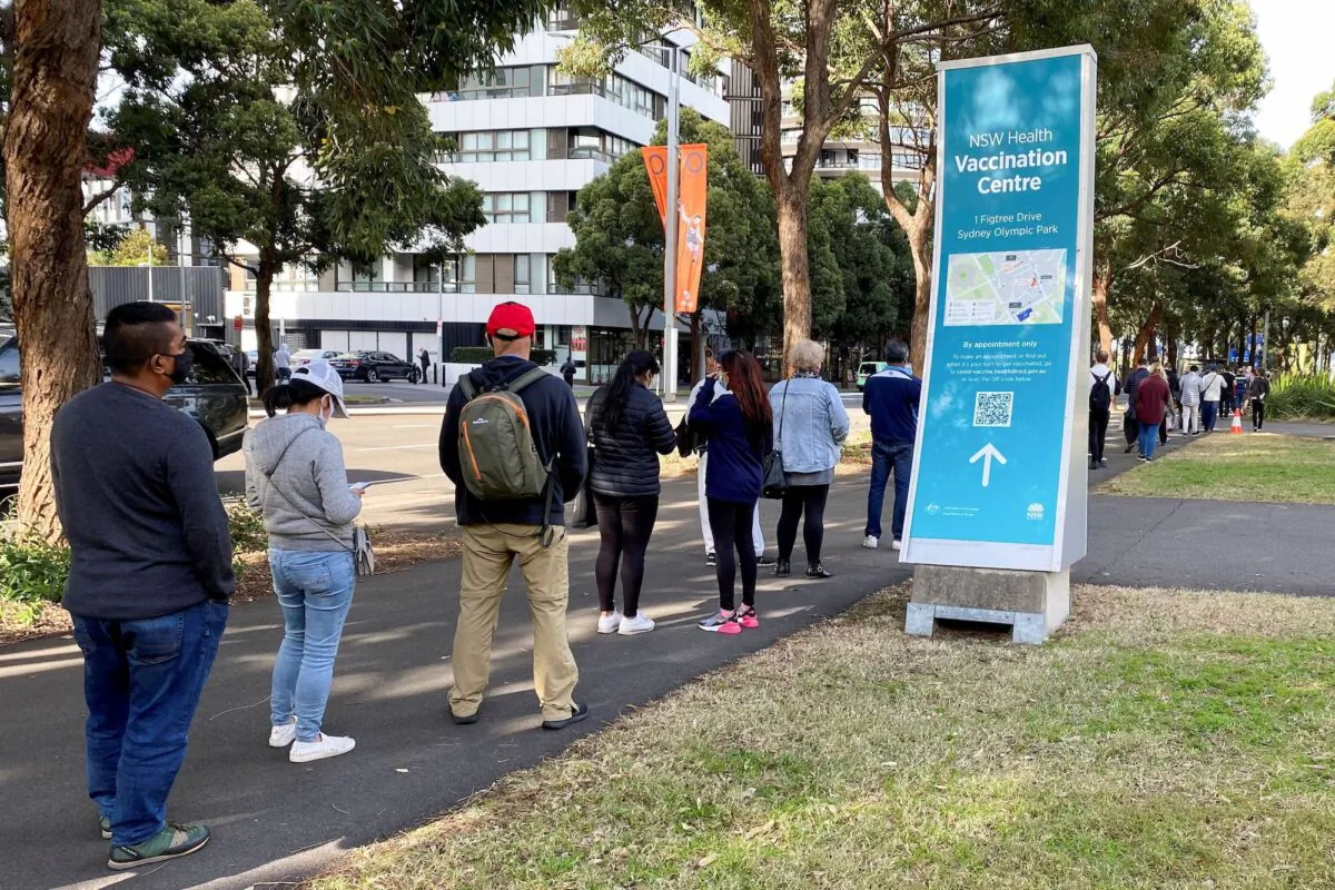 People wait in line outside a coronavirus disease (COVID-19) vaccination centre at Sydney Olympic Park in Sydney, Australia, on June 23, 2021. (Jane Wardell/Reuters)