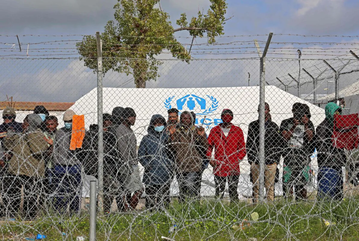 Asylum seekers staying in the Pournara temporary accommodation centre protest over delays in their application process and what they described as the inhumane living conditions in the camp, in Kokkinotrimithia, some 20 kilometres outside the Cypriot capital Nicosia, on Feb. 1, 2021. (Christina Assi/AFP via Getty Images)