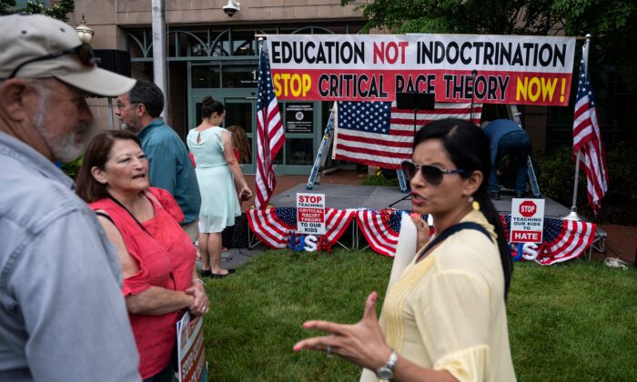 People talk before the start of a rally against critical race theory (CRT) being taught in schools, at the Loudoun County Government center in Leesburg, Va., on June 12, 2021. (Andrew Cballlero-Reynolds/AFP via Getty Images)