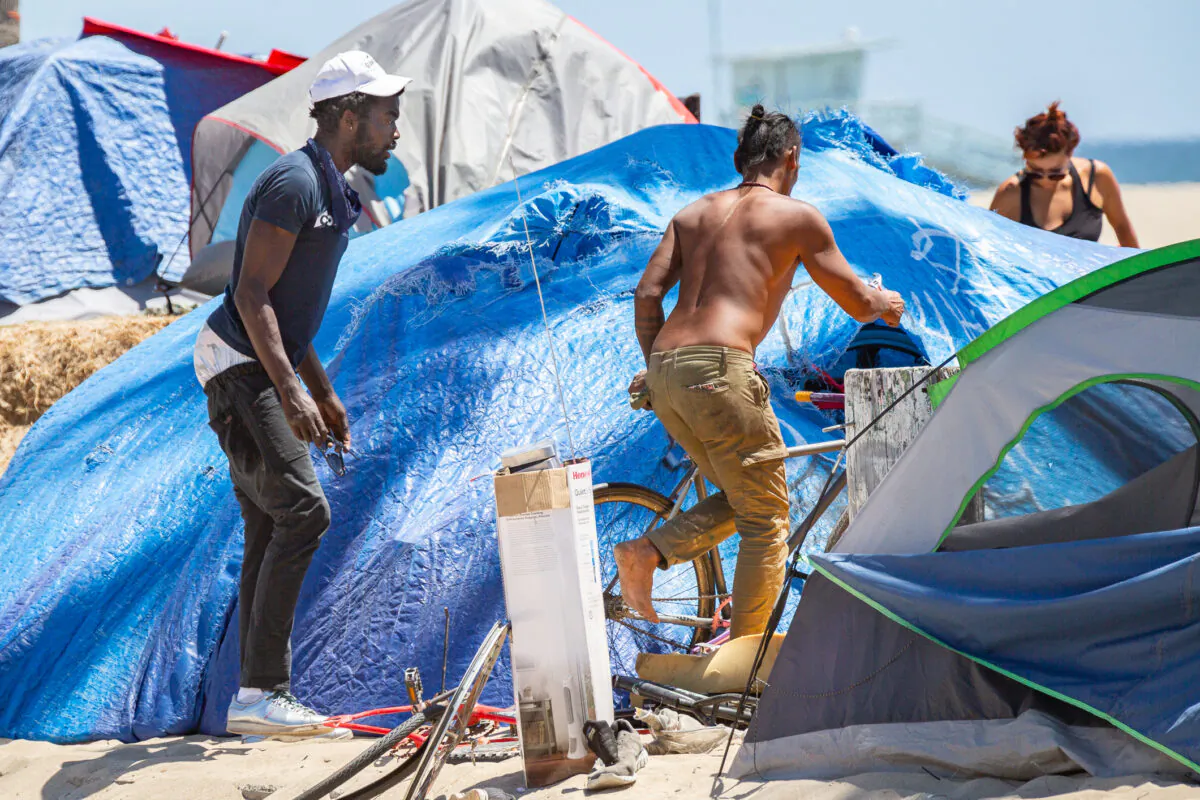 Homeless individuals in Venice Beach, Calif., roam around their encampments on June 8, 2021. (John Fredricks/The Epoch Times)