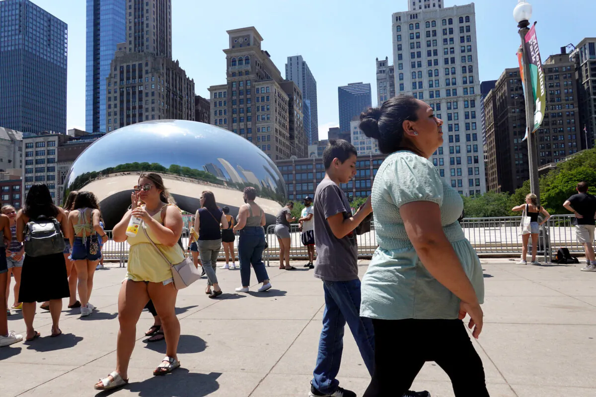 People visit Anish Kapoor's Cloud Gate sculpture in downtown Chicago, Ill., on June 11, 2021. (Scott Olson/Getty Images)