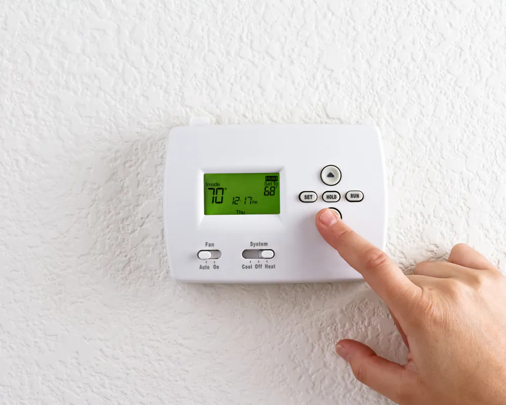 The rule of thumb is over an eight-hour period, you’ll save 1% for every 1 degree you set the dial back. 
(topseller/Shutterstock)