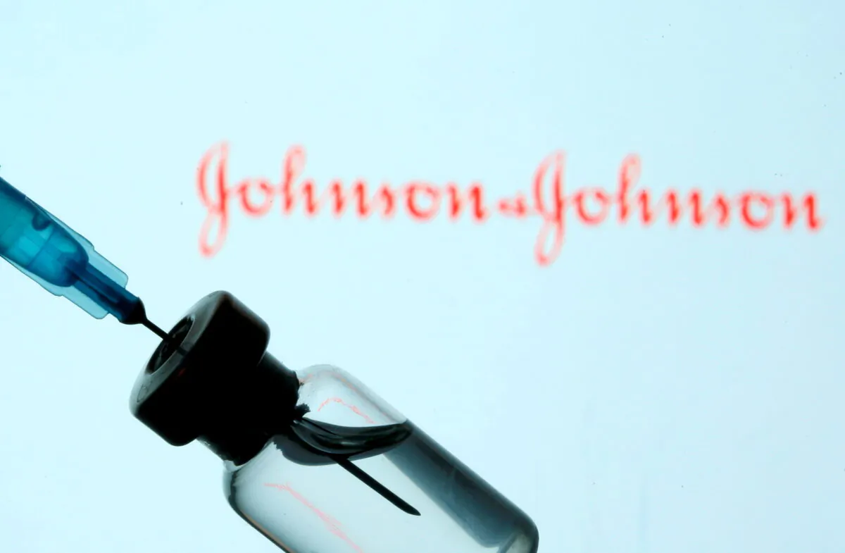 A vial and syringe are seen in front of a displayed Johnson & Johnson logo in this illustration taken on Jan. 11, 2021. (Dado Ruvic/Illustration/Reuters)