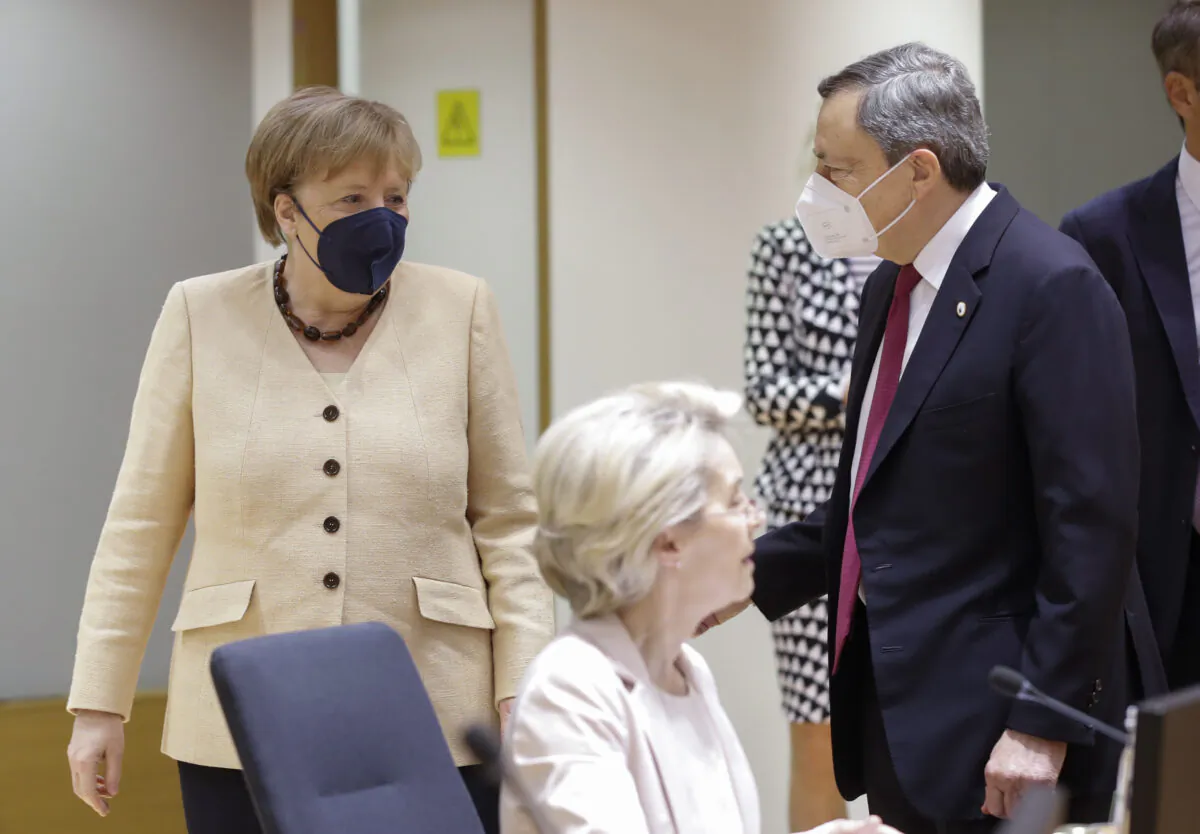 German Chancellor Angela Merkel, left, talks to Italian Prime Minister Mario Draghi during an EU summit at the European Council building in Brussels, on June 25, 2021. (Olivier Hoslet/Pool Photo via AP)